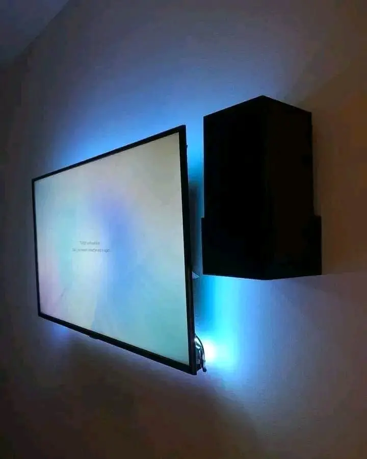 Wall-mounted television with blue backlighting