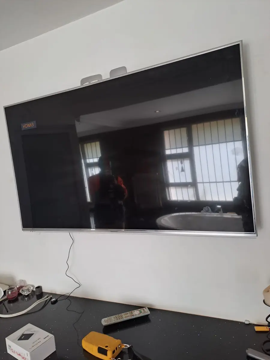 Television mounted on a wall with equipment below